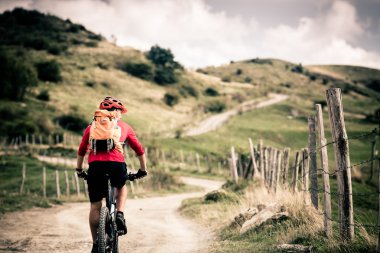 Mountain bike rider on country road, track trail in inspirationa clipart