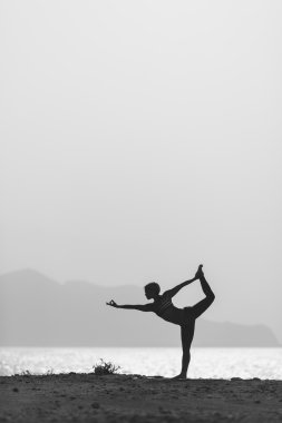 Woman meditating in yoga pose silhouette