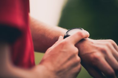 Runner training and using heart rate monitor smart watch
