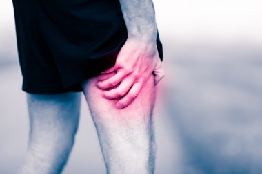 Leg pain, man holding sore and painful muscle