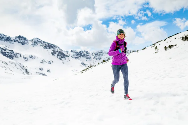 Happy woman winter trail running in beautiful inspirational land — Stockfoto