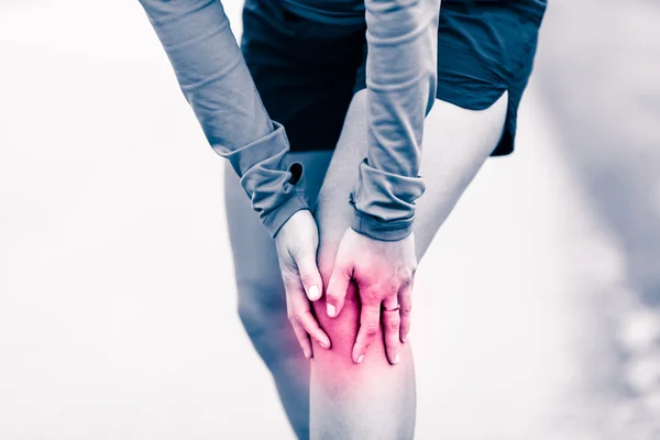 Knee pain, woman holding sore and painful leg — Stock Photo, Image