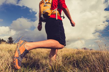 Hiking man with backpack in mountains