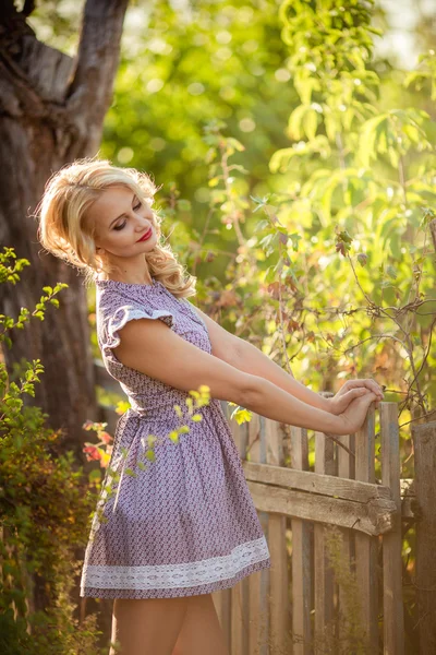 Blonde woman in spring garden — Stock Photo, Image
