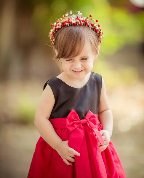 Little girl in wreath and elegant dress — Stock Photo, Image