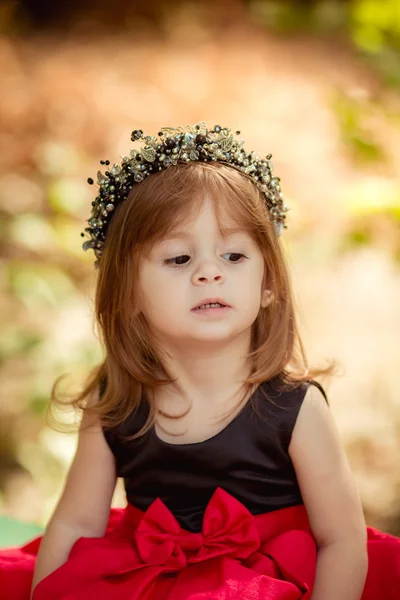 Little girl in wreath and elegant dress — Stock Photo, Image