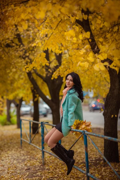 Girl with maple leaves in autumn garden — Stock Photo, Image