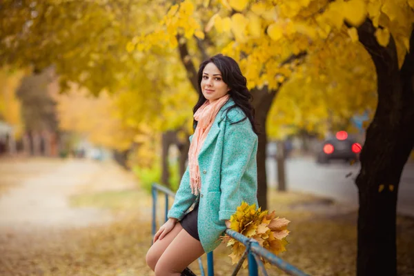 Girl with maple leaves in autumn garden — Stock Photo, Image