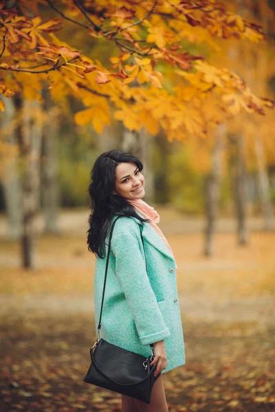 Beautiful girl in autumn garden — Stock Photo, Image
