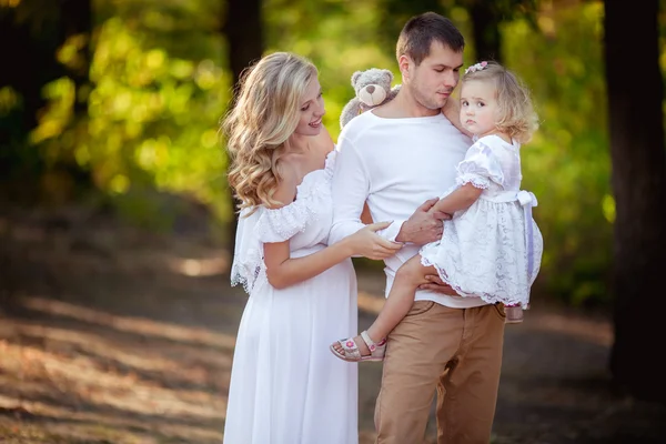 Beautiful family of three in green garden — Stock Photo, Image