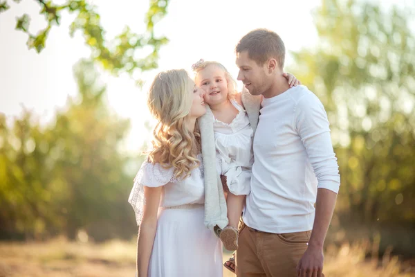 Bella famiglia di tre persone nel giardino verde — Foto Stock