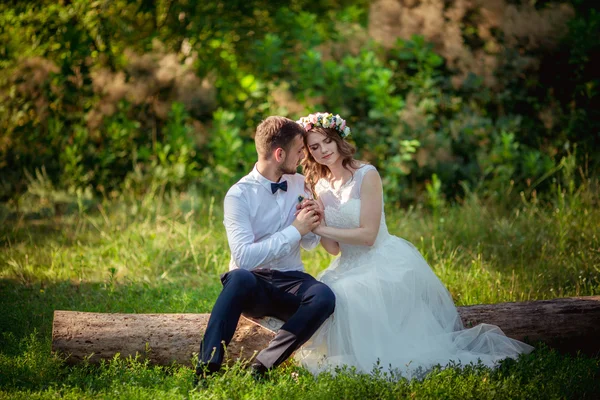 Happy bride and groom in green park — Stock Photo, Image