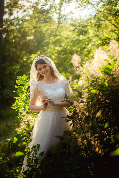 Bride in white dress in the garden