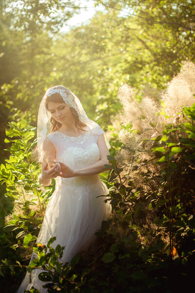 Bride in white dress in the garden