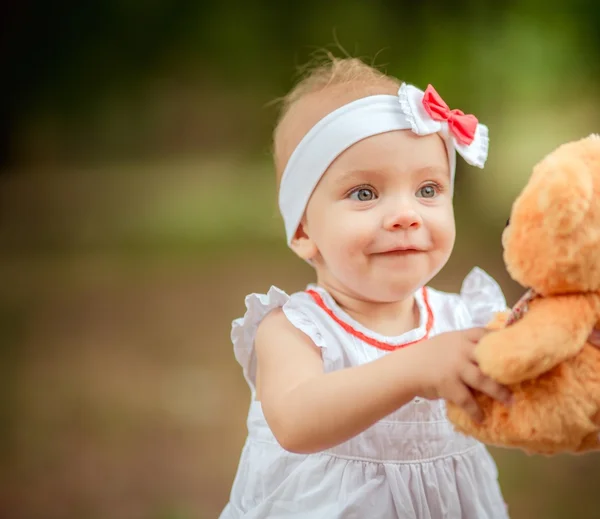 Beautiful baby girl with toy bear — Stock Photo, Image