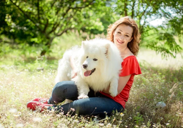 Γυναίκα με σκύλο Samoyed φυλή στο πάρκο — Φωτογραφία Αρχείου