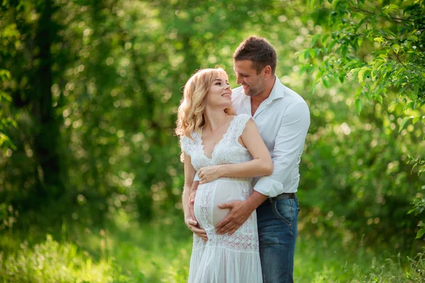 Mulher grávida com o marido no jardim — Fotografia de Stock