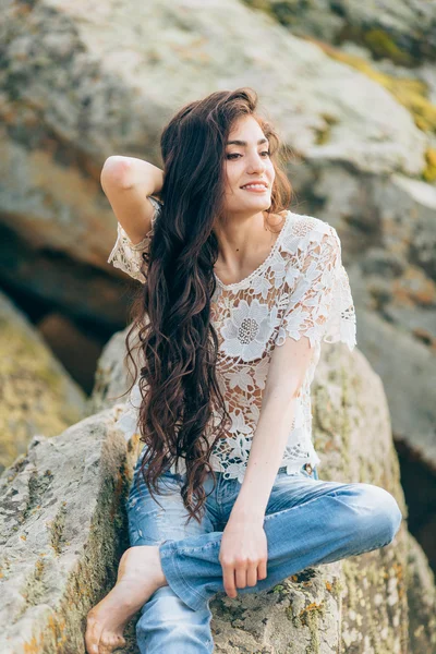 Vacker kvinna på en bakgrund av stenar — Stockfoto