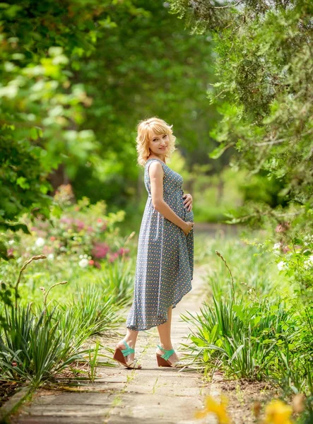 Mujer rubia embarazada en la naturaleza —  Fotos de Stock