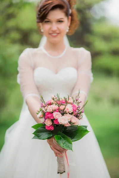 Beautiful bride in white dress with bouquet — Stock Photo, Image