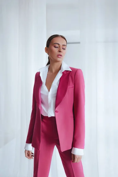 Girl in a pink suit. Business style.Trend of 2021. Natural female beauty.