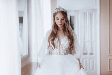 Enfes bir iç güzellikte, beyaz elbiseli, açık renk makyajlı güzel bir gelin. 