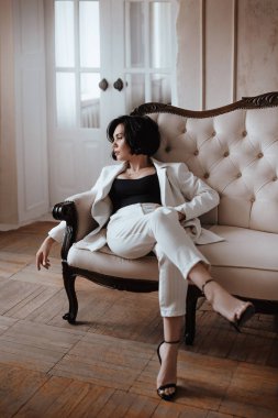 Zarif beyaz takım elbiseli muhteşem bir kadın. Doğal renkler. Doğal kadın güzelliği.