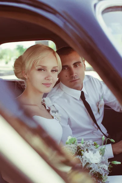 Braut und Bräutigam im Auto — Stockfoto