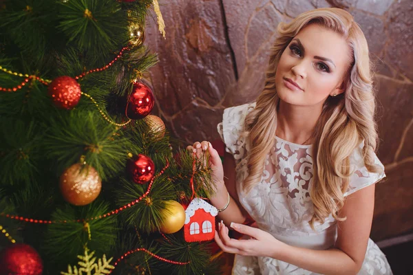 Woman near a Christmas tree — Stock Photo, Image