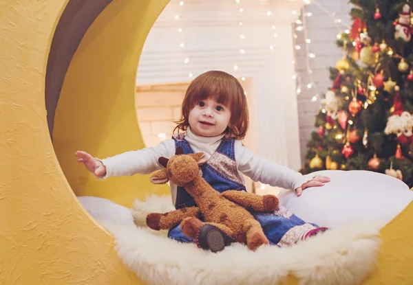 Baby girl near a Christmas tree — Stock Photo, Image