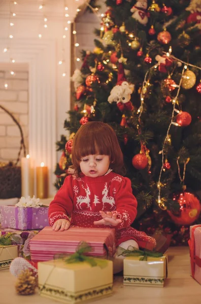 Baby girl near a Christmas tree — Stock Photo, Image