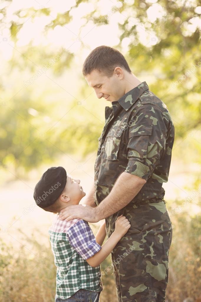 Boy and soldier in a military uniform