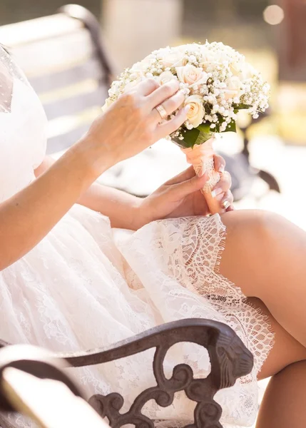 Bride sitting on a bench — Stock Photo, Image