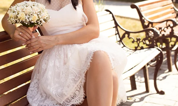 Bride sitting on a bench