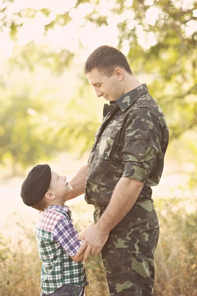 Boy and soldier in a military uniform — Stock Photo, Image