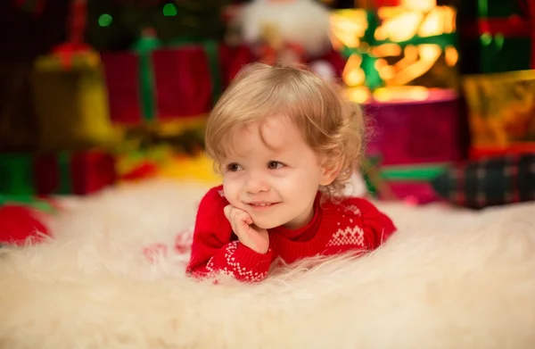 Little girl over Christmas gifts — Stock Photo, Image