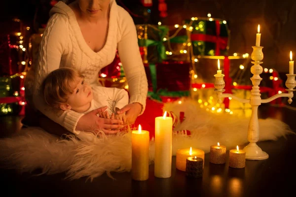 Mother and daughter over Christmas fir tree — Stock Photo, Image