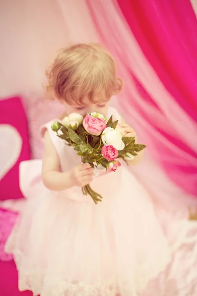 Beautiful little girl with flowers — Stock Photo, Image