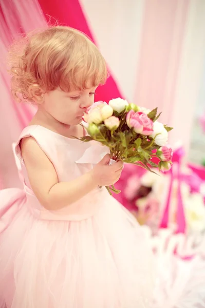 Beautiful little girl with flowers — Stock Photo, Image