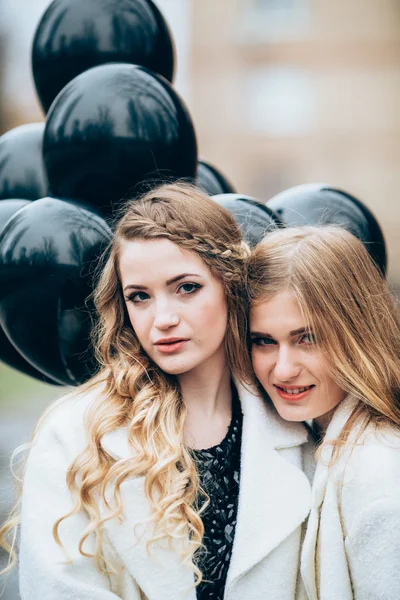 Beautiful girls with black balloons — Stock Photo, Image