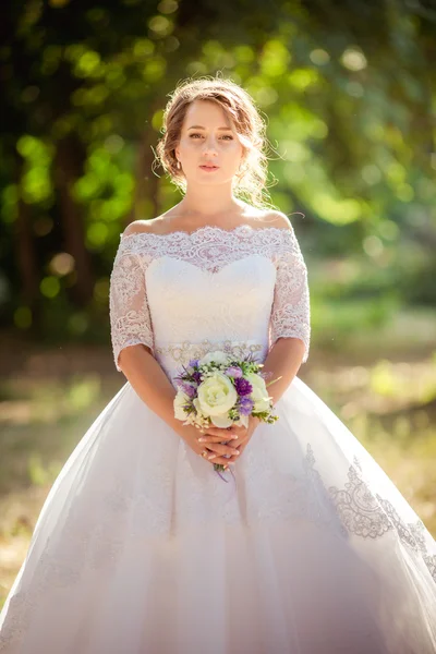 Beautiful romantic bride in park — Stock Photo, Image