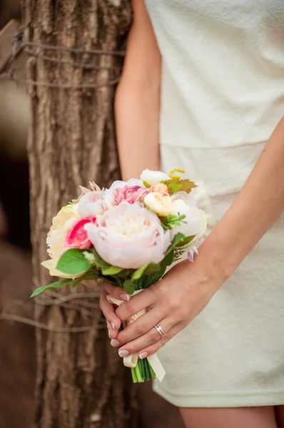 Mãos de noiva com flores — Fotografia de Stock