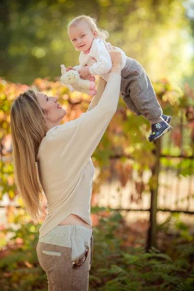 mother throws up baby girl in the air