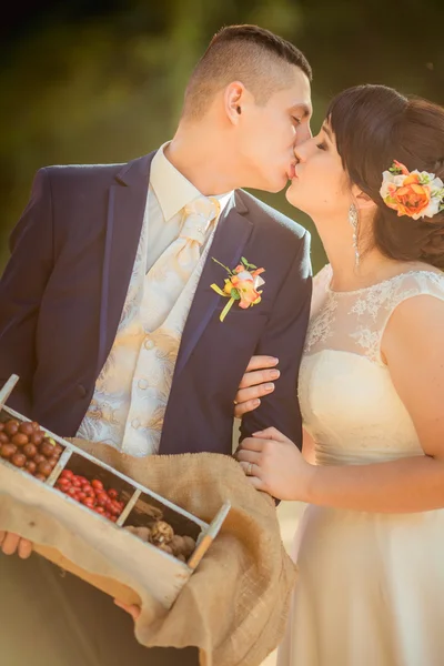 Bride and groom with berries and nuts — Stock Photo, Image