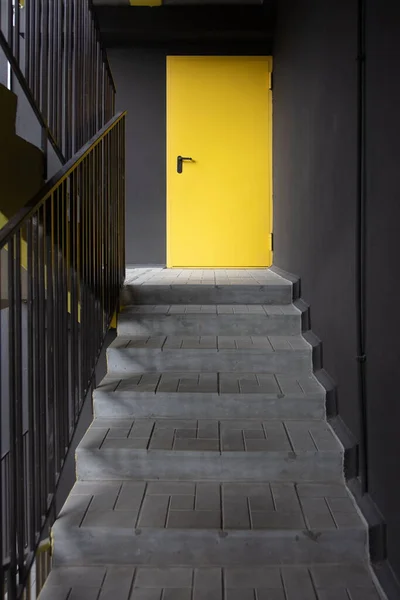 bright yellow external fire escape of new multilevel parking building