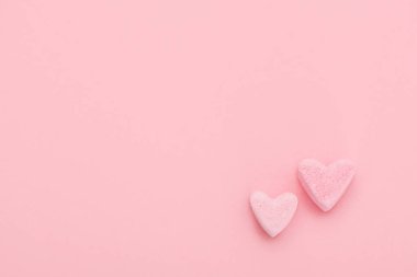 Pembe arka planda iki küçük tatlı kalp. Mutlu Sevgililer Günleri
