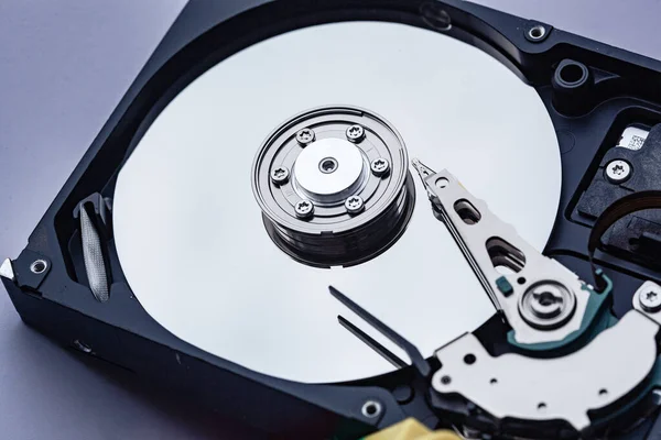 An open computer hard drive for repair. HDD. Components for ps. Storage and restoration of digital data