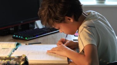 Çocuk masaya oturur ve okulda verilen görevi öğrenir.
