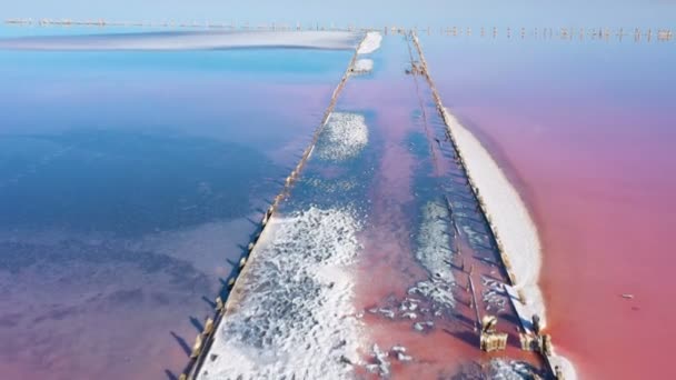 Pink Salt Lake Wooden Pillars Abandoned Salt Extraction Factory Aerial — Stock Video