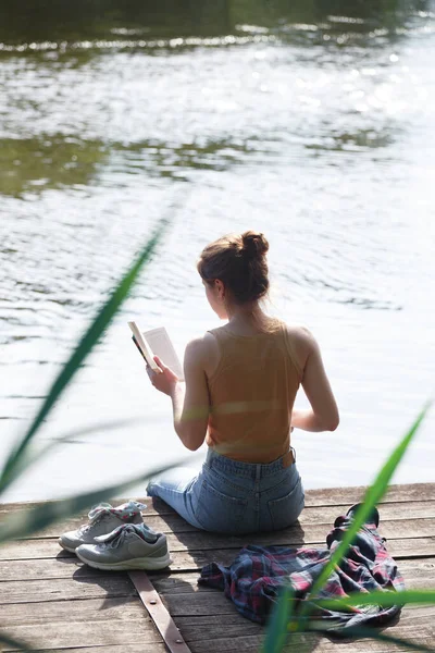 Girl Sitting Pier Reading Boo — 스톡 사진